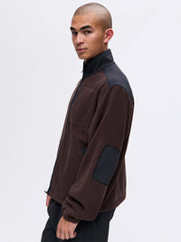 Model wearing RecFleece Relaxed Full Zip in Brown with contrast RecTrek shoulder panels and elbow patches.