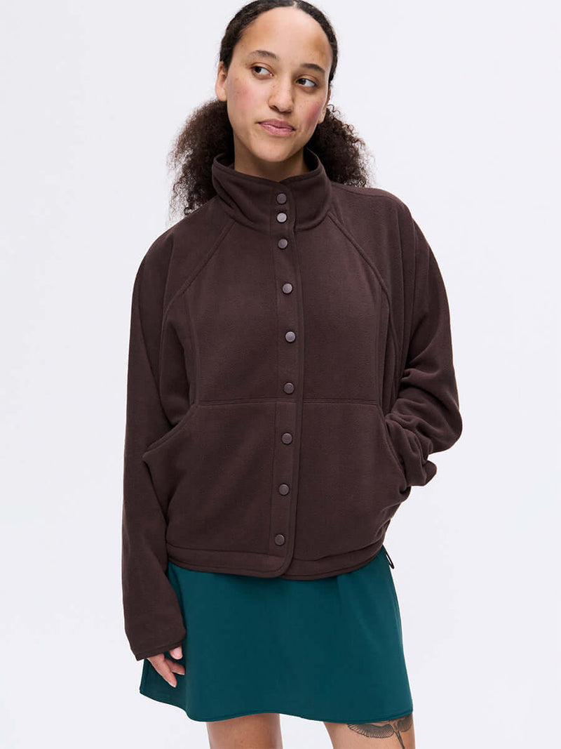 Model wearing RecFleece Snap Jacket in Dark Brown, featuring snap front and roomy dolman sleeves.