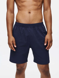 Model posing in RecTrek 7" Short in Navy, featuring an adjustable drawstring and stretchy fabric.