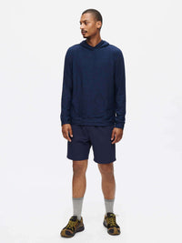 Model posing in navy RecTrek 7" Short with zippered pockets, styled for casual outdoor activities.