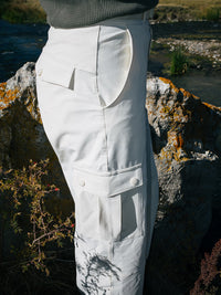 Side view of RecTrek Cargo Pant in White, featuring utility-style pockets and a relaxed fit.