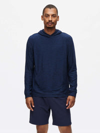 Model standing in RecTrek 7" Short with a relaxed fit, wearing a long sleeve hoodie in navy.