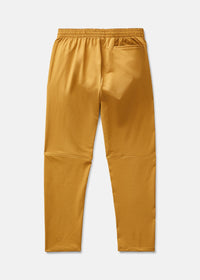Back view of RecTrek Pant in Gold, featuring an elastic waistband and zippered pockets for secure storage.