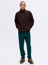 Model standing in the RecTrek Pant in Green, with the relaxed fit and comfortable waist drawstring.