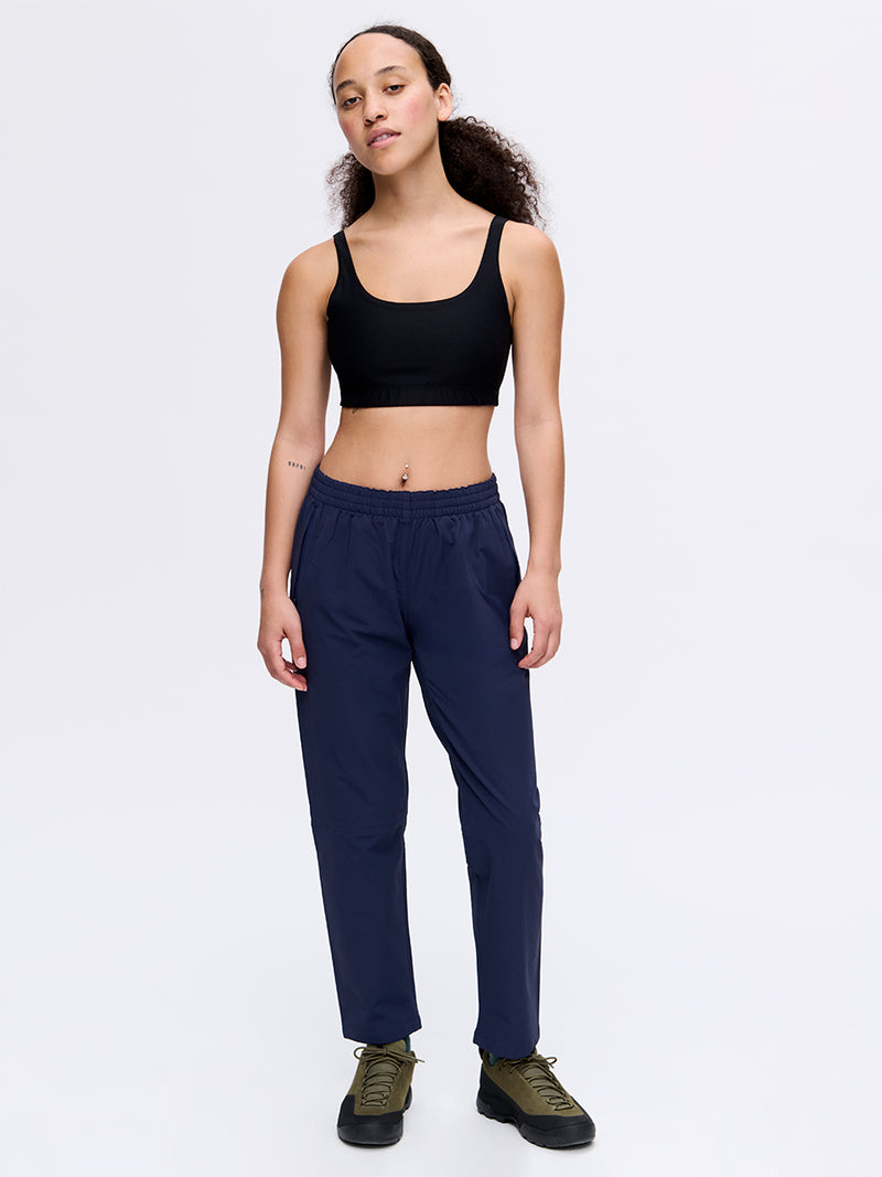 Model standing in RecTrek 26" Pant in Navy, featuring a custom-fit drawstring and breathable fabric.