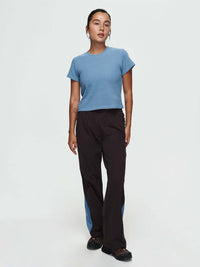 Model standing in RecTrek Zip Pant in Black with blue mesh panels for ventilation.