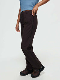 Model wearing RecTrek Zip Pant in Dark Brown, featuring zippered outer seams for ventilation.