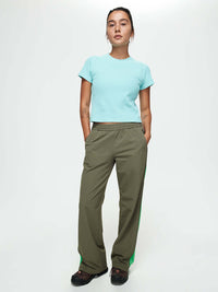 Model wearing RecTrek Zip Pant in Olive, showing front pockets and relaxed fit for activewear.