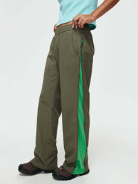 Model posing in RecTrek Zip Pant in Olive, featuring mesh panel zippers along the outer seams for ventilation.
