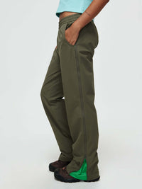 Model wearing RecTrek Zip Pant in Olive, featuring zippers and mesh panels for ventilation.