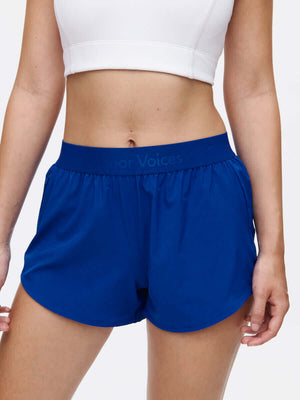 Model wearing Relay 3" Short in Blue, featuring an elastic waistband for comfort during workouts.