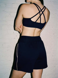 Model from behind wearing Sport Short in Navy with a comfortable fit and adjustable bungee cord waistband.