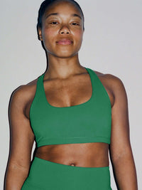 Model wearing Star Bra in Green, featuring a U-neck design and wide shoulder straps for support.