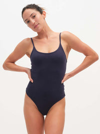 Model posing in Strappy Bodysuit in Navy, featuring adjustable spaghetti straps and a soft fit.