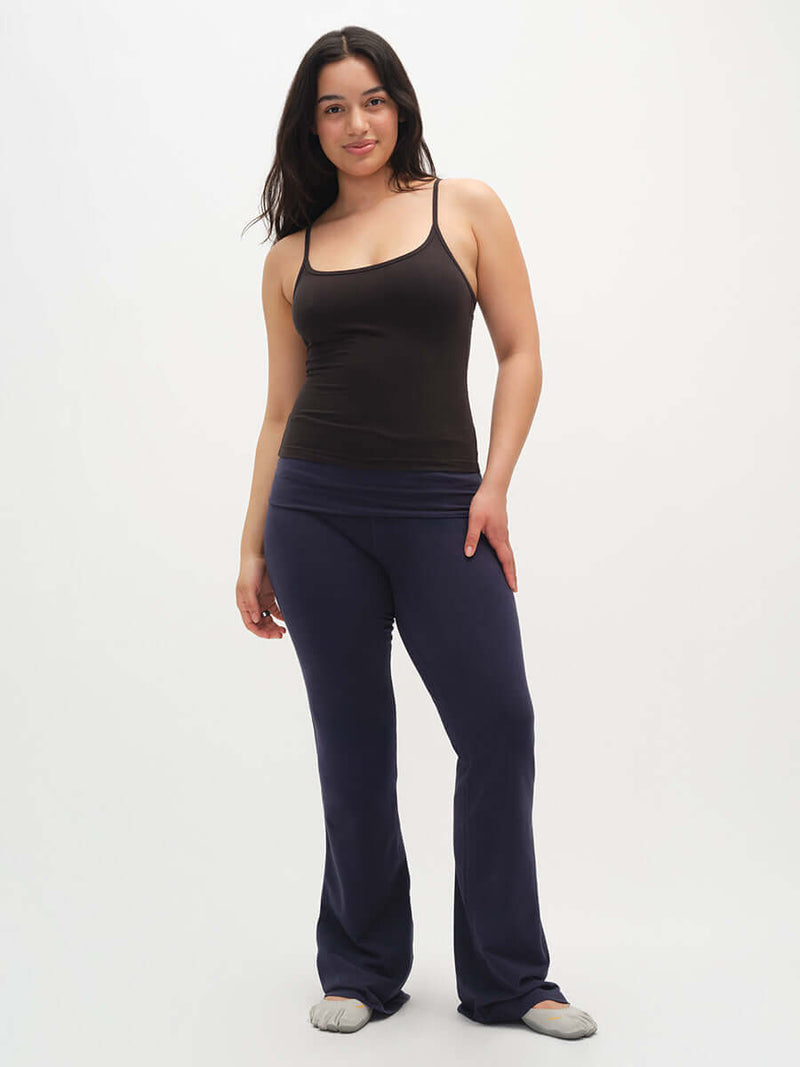 Model standing in Strappy Tank in Black, featuring adjustable spaghetti straps and a fitted style, paired with comfy pants.