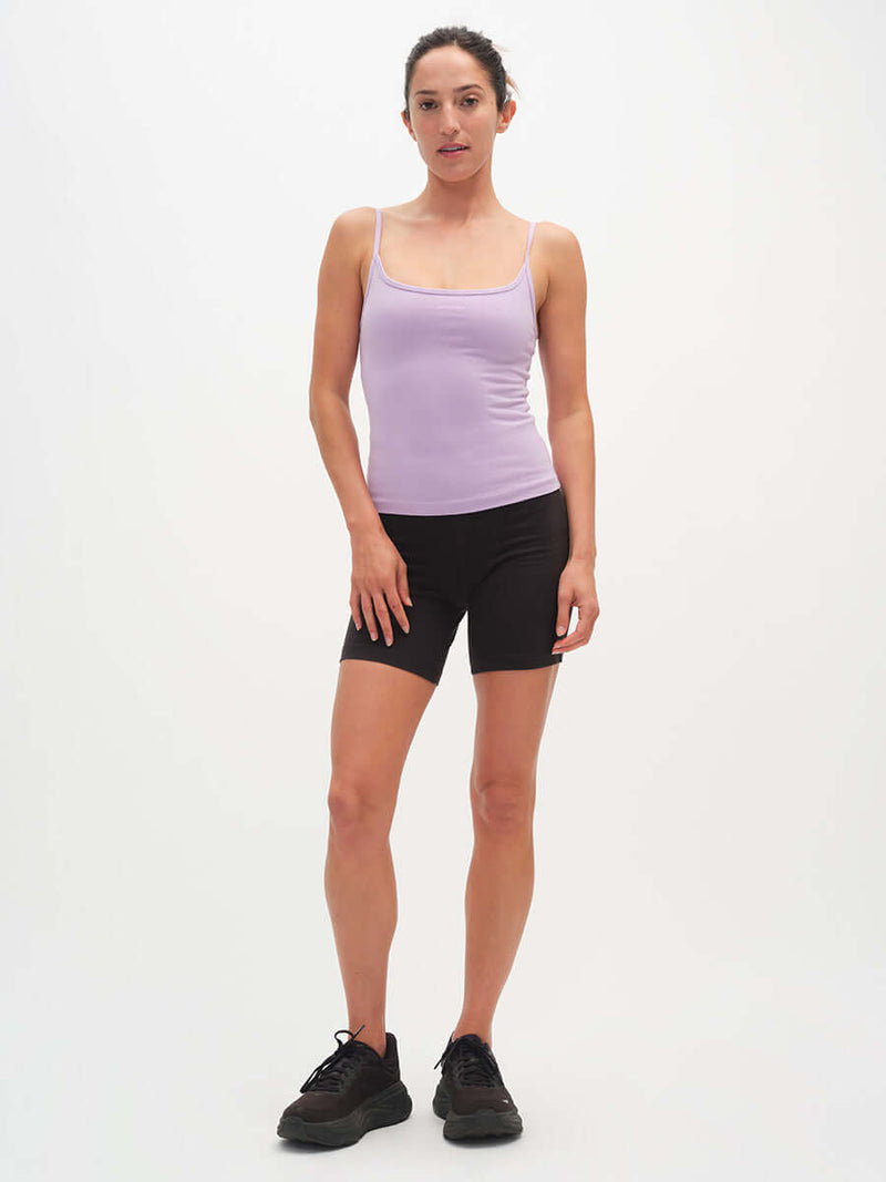Model standing in Strappy Tank in Cotton Candy with adjustable spaghetti straps, paired with black shorts.