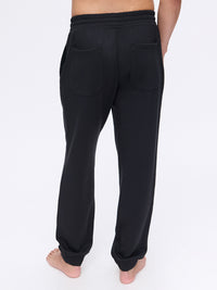 Back view of Stratus Sweatpant in Black, showing relaxed fit and pockets.