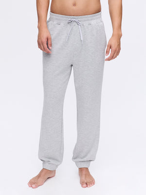 Model wearing Stratus Sweatpant in Grey, showing relaxed silhouette and soft fabric for lounging.