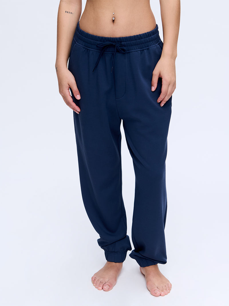 Model wearing Stratus Sweatpant in Navy, relaxed fit with an elastic waistband for comfort.