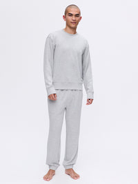 Model wearing Stratus Sweatshirt in Light Gray, heavyweight fabric provides warmth and comfort for lounging.