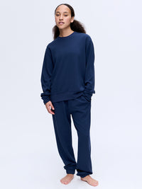 Model wearing Stratus Sweatshirt in Navy, relaxed fit for lounging and comfort.