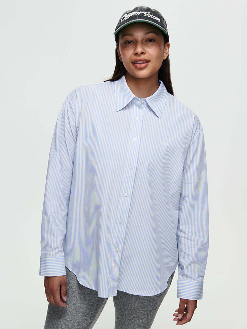 Model wearing a Striped Sun Shirt, showcasing an oversized fit and subtle stripes in lightweight cotton.