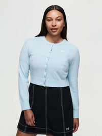 Model wearing Sugar Cardigan in Light Blue, lightweight knit cotton cashmere with hand-embroidered signature.