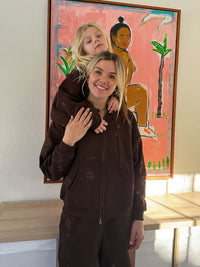 Woman and child smiling together, wearing Sunny Hoodie in Brown, featuring a 2-way zipper and relaxed fit.