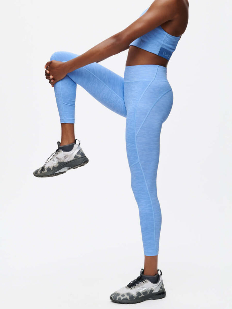 Model stretching in TechSweat Core 7/8 Legging in Sky Blue, featuring a supportive engineered waistband.