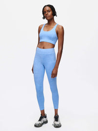 Model standing in TechSweat Core 7/8 Legging in Light Blue, featuring a breathable fabric and engineered waistband.