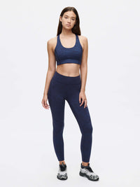 Model posing in TechSweat Core 7/8 Legging in Navy, featuring a supportive waistband for workouts.
