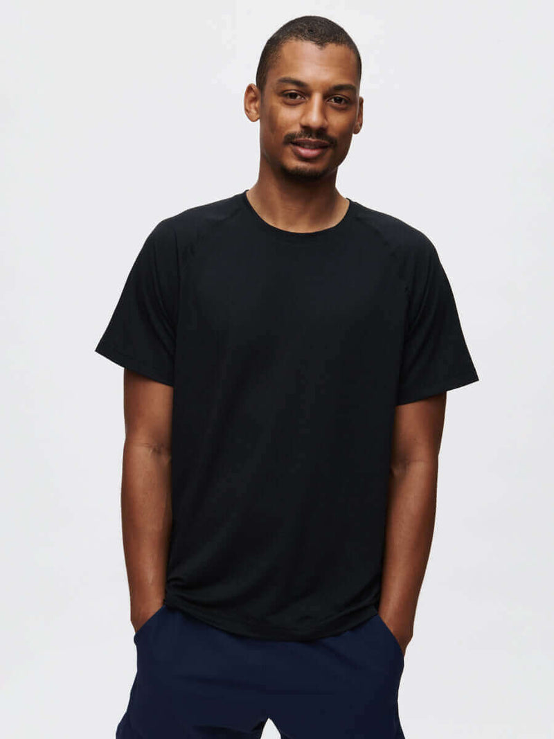 Model wearing ThinkFast Mesh Shortsleeve in Black with technical fabric and built-in cooling technology.