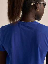 Back view of ThinkFast Mesh Shortsleeve in Blue showing breathable fabric with a tag detail and a relaxed fit.