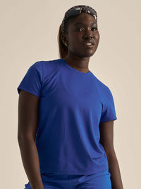 Model wearing ThinkFast Mesh Shortsleeve in vibrant blue, showing cooling fabric and relaxed fit.