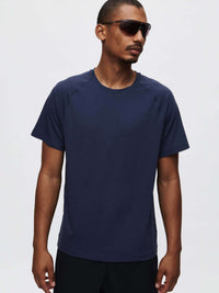 Model wearing ThinkFast Mesh Shortsleeve in Navy, featuring a classic fit and cooling fabric for activewear.