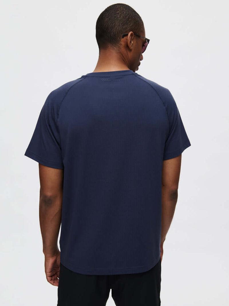 Back view of ThinkFast Mesh Shortsleeve in Navy, featuring a classic fit and cooling fabric for activewear.