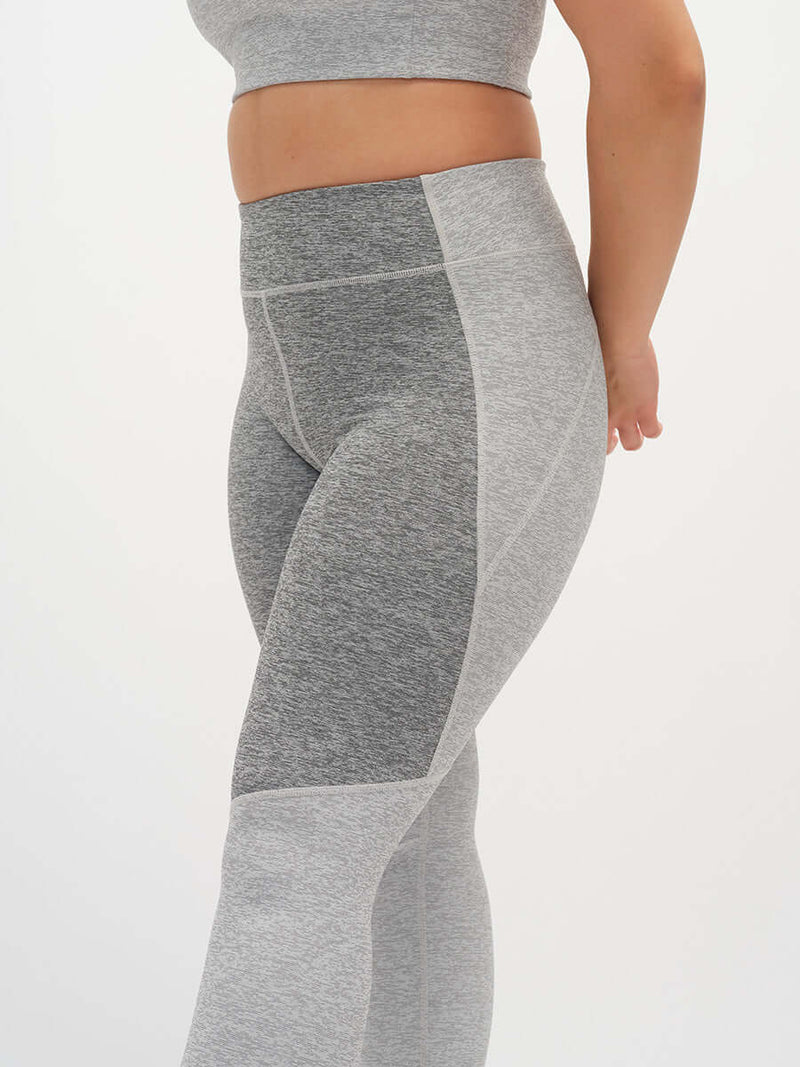 Model in profile view wearing Two Tone 7/8 Legging, showing the 2-tone paneling design.