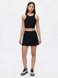 Model wearing Venus Crop Top in Black, with a cropped silhouette and V-back design.