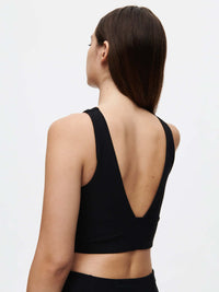 Back view of Venus Crop Top in Black, featuring a V-back shape and cropped silhouette.