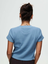 Back view of Waffle Baby Tee in Sky Blue, with the fitted waffle knit fabric and short sleeves.