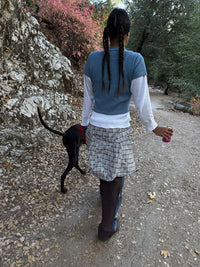 Model walking a dog on a trail wearing Waffle Baby Tee in Blue, fitted waffle knit fabric for active days.