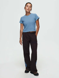Model wearing Waffle Baby Tee in Blue with fitted style, paired with relaxed pants.