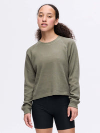 Model wearing Waffle Longsleeve in Olive, soft waffle knit fabric with a boxy fit.