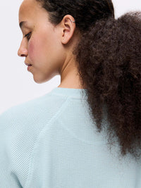 Back view of Waffle Longsleeve in Light Blue, showing the soft waffle knit texture and relaxed fit.