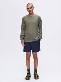 Model wearing Waffle Longsleeve in Olive, relaxed fit with long sleeves, styled for activewear.
