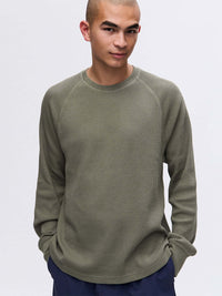 Model wearing Waffle Longsleeve in Olive, featuring a relaxed fit and soft waffle knit fabric.