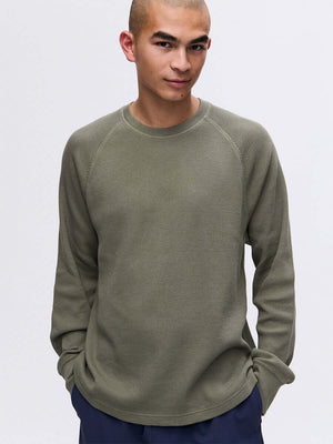 Model wearing Waffle Longsleeve in Olive, featuring a relaxed fit and soft waffle knit fabric.