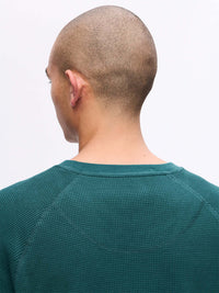 Back view of Waffle Longsleeve in deep teal, with the relaxed fit and textured knit fabric.