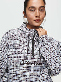 Model wearing Windbreaker in mineral blue plaid with an adjustable hood, for everyday adventures.