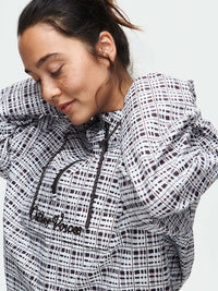 Model wearing Windbreaker in mineral blue plaid, featuring a lightweight and water-resistant fabric.